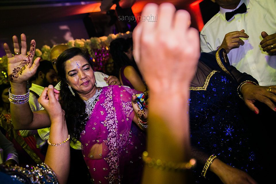 Asian wedding guests dancing