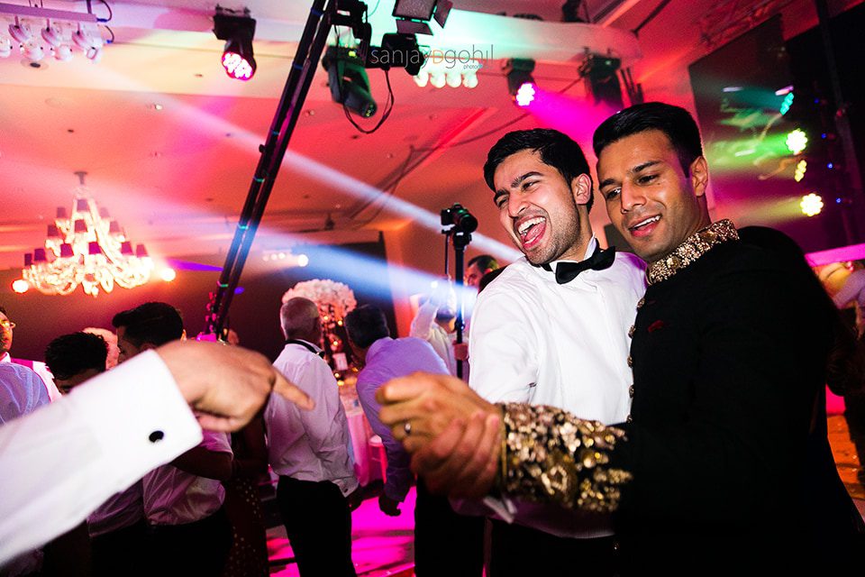 Asian wedding guests dancing