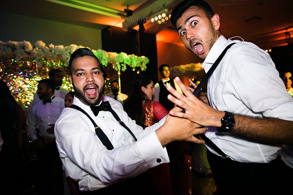 Asian wedding guests dancing