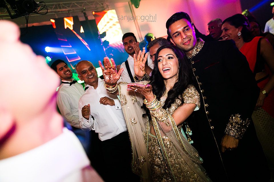 Asian wedding guests dancing