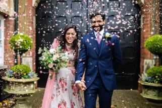 Wedding couple being showered with confetti