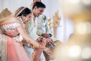 Wedding couple smiling during Hindu wedding