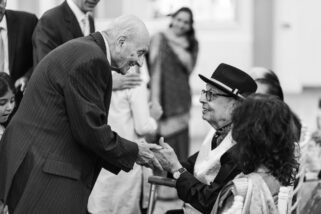 Asian wedding guests shaking hands