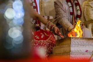 Bride pouring seeds into the fire
