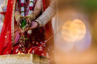 Bride pouring seeds into the fire