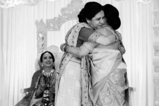 Mothers of bride and groom hugging