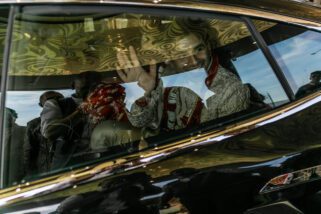 Groom waving as car goes off