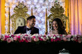 Bride and groom smiling at reception party