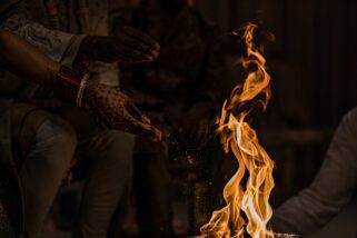 Seeds being thrown into the fire during Asian wedding ceremony