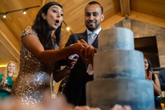 Bride and groom cutting wedding cake