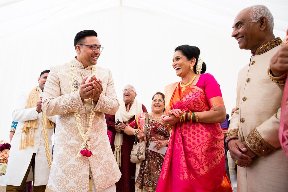 Asian wedding groom walking into the mandap