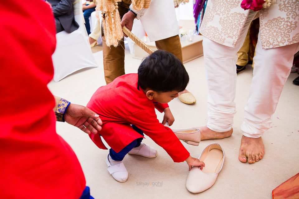 Groom's shoes being taken by bride's side