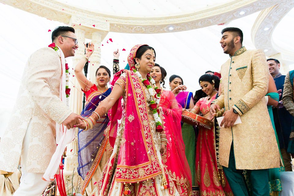 Bride leading last phera while being showered with flowers