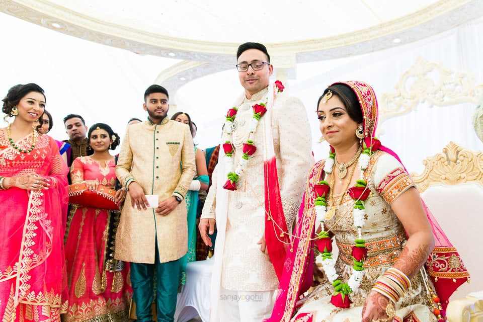 Hindu wedding bride sitting down before groom