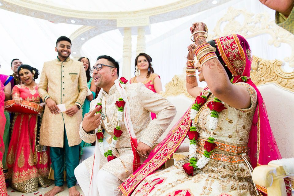 Hindu wedding bride sitting down before groom