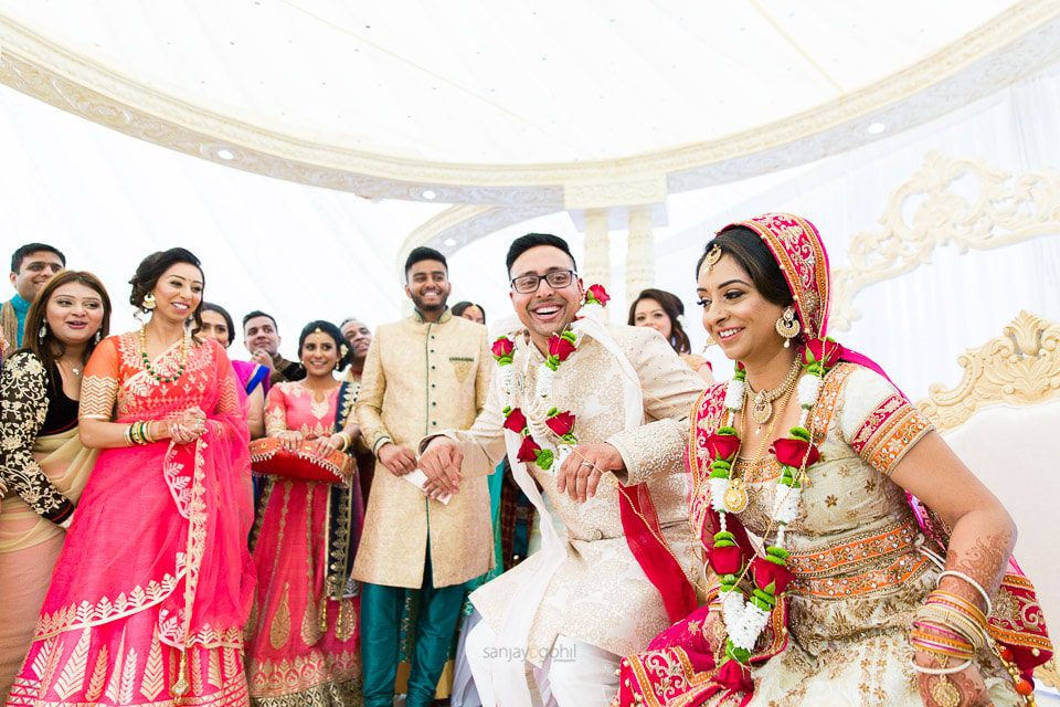 Hindu wedding bride sitting down before groom