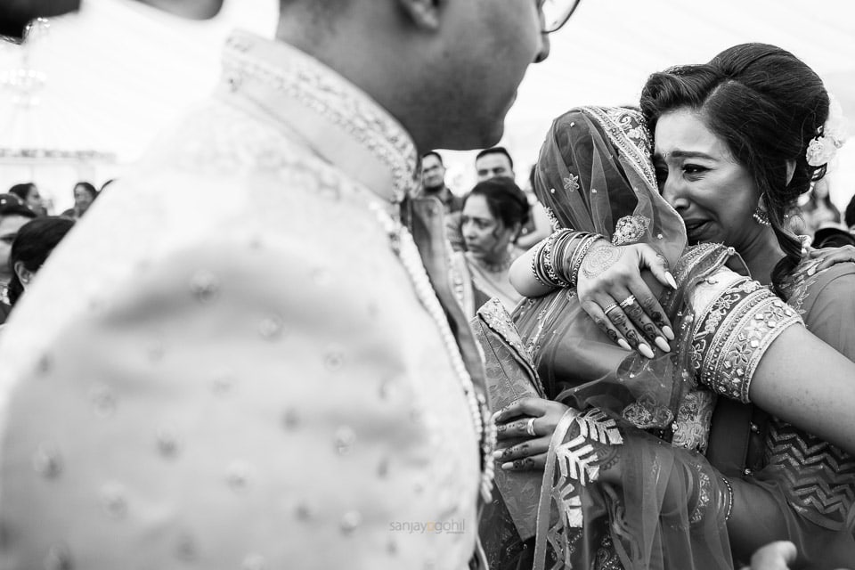 Bride hugging sister 