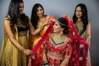 Bridesmaids helping bride getting ready