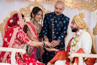 Parents of the bride giving hand away in marriage