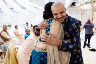 Father of the bride hugging