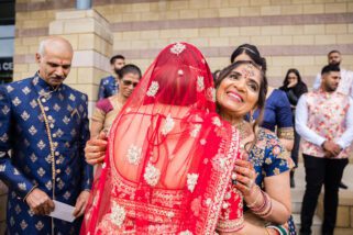 Bride hugging parents after wedding