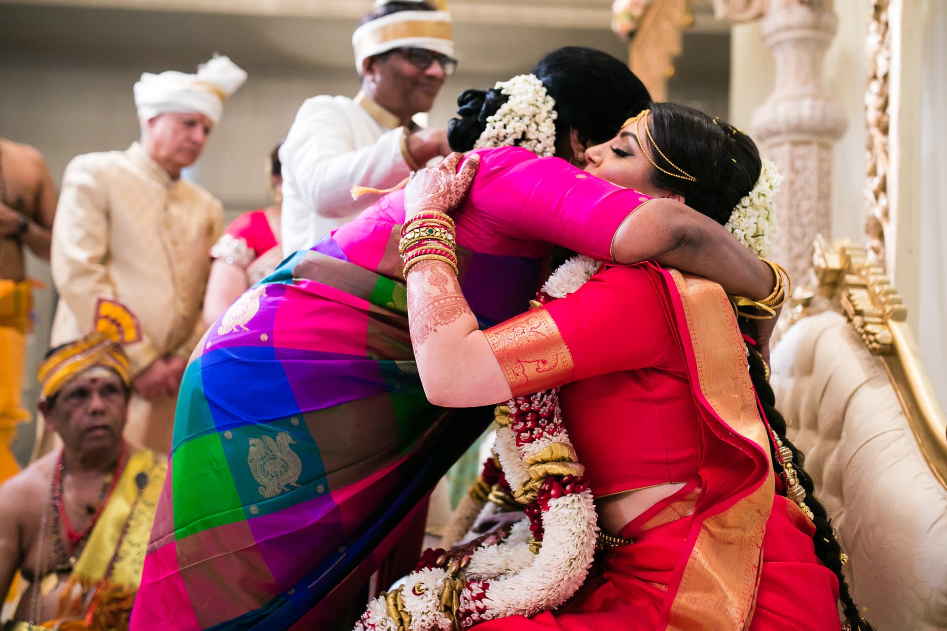 Grooms mother hugging bride