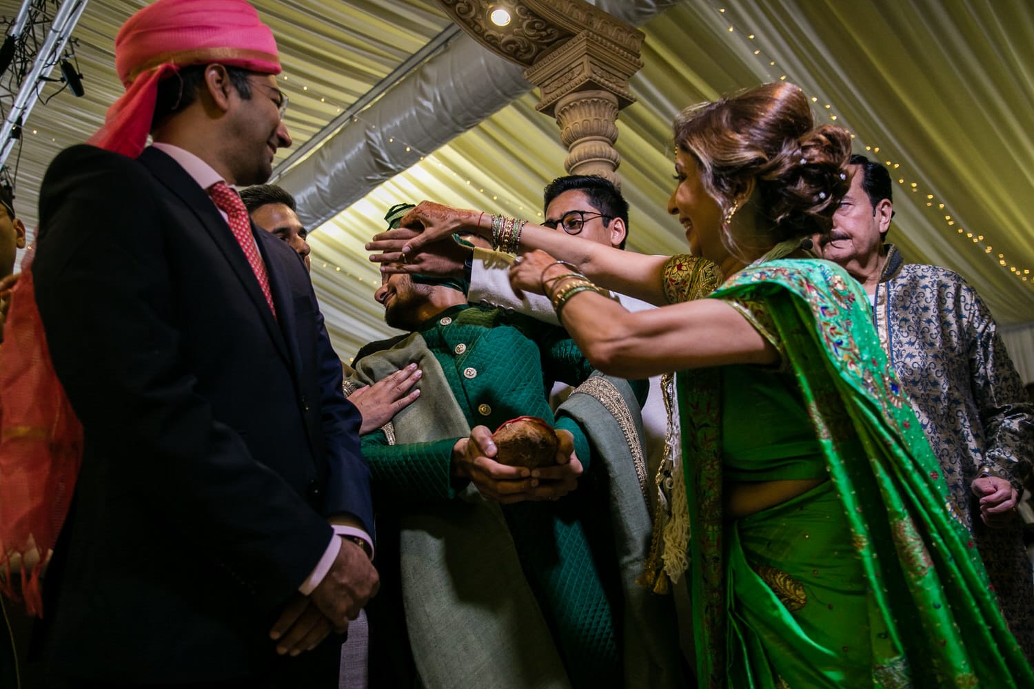 Mother of the bride grabbing the groom's nose