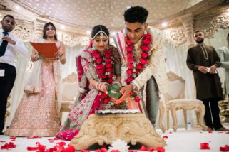 Bride and groom placing seeds into the fire
