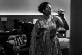 bride having beer before wedding reception