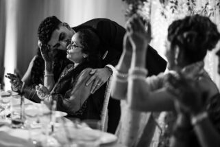 Groom kissing mum on cheek