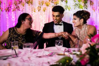Mother of the groom holding brides hand